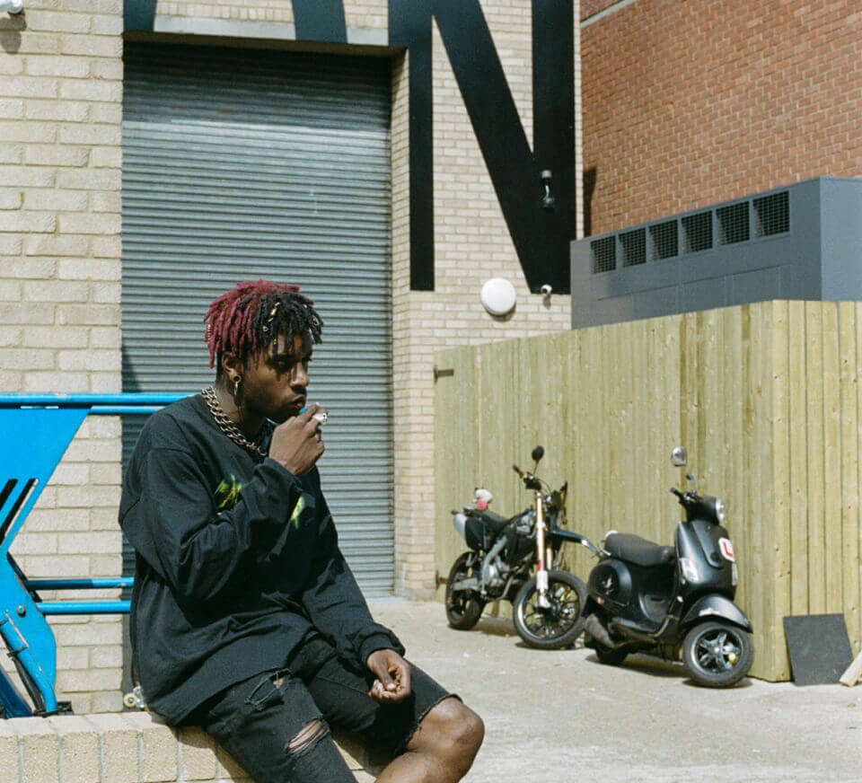 Man smoking cigarette outside building