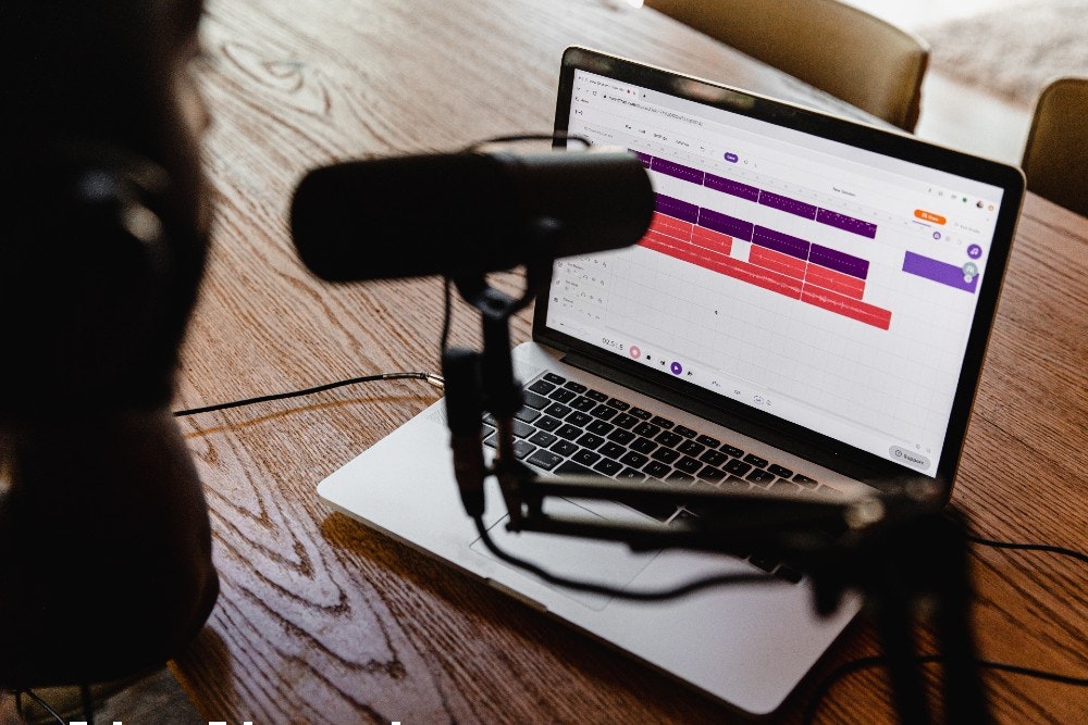 Close up snap of a microphone on top of a laptop. Recording a podcast in LA? Book a podcast studio here.