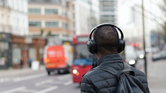 This image may contain: person, human, headphones, headset, electronics, tarmac, asphalt, road