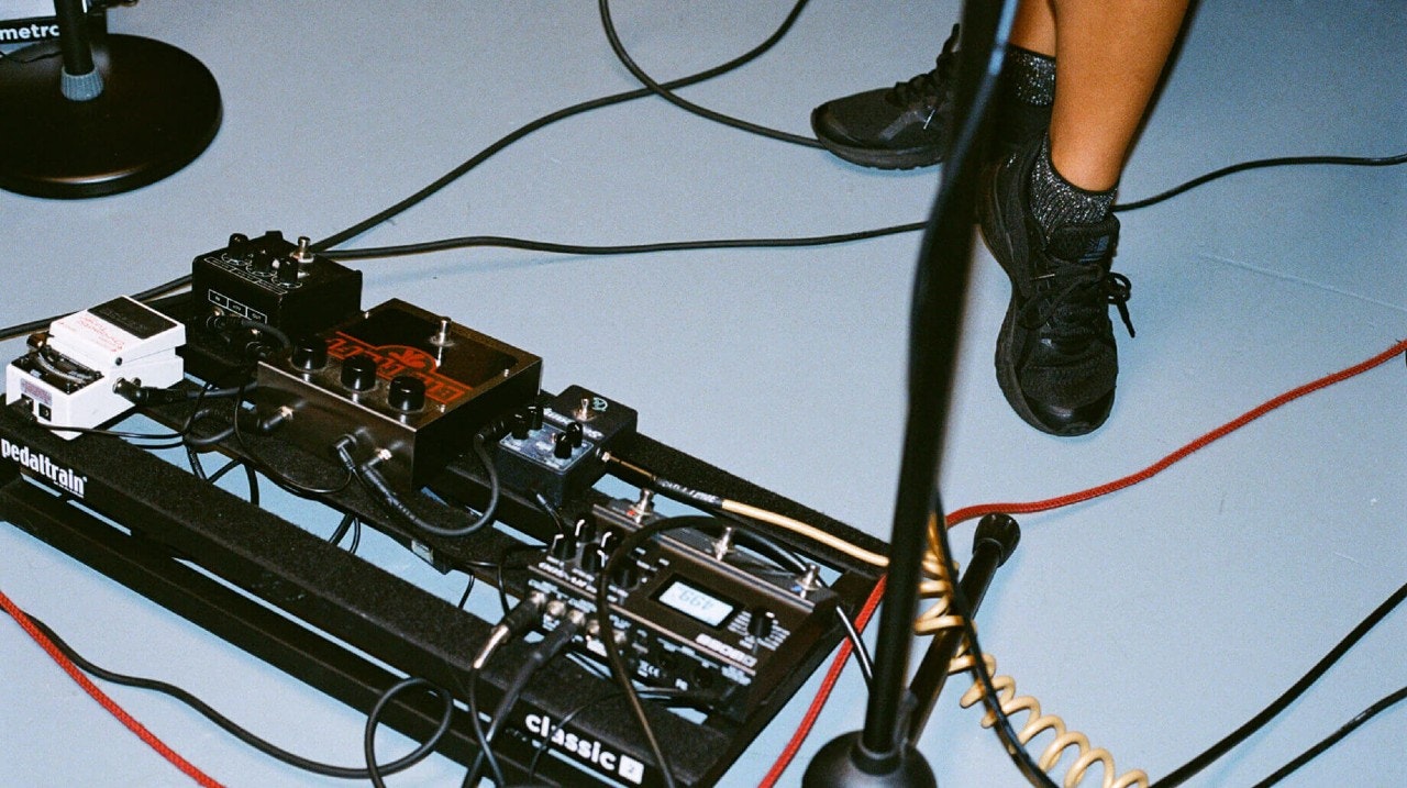 Guitar pedals and microphone stand inside our Chicago studios for musicians, podcasters and dancers