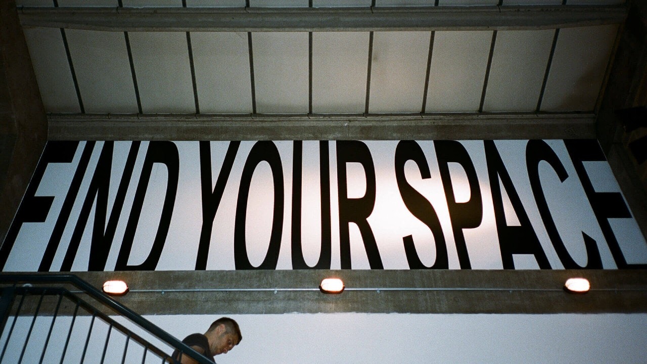 This image may contain: text, person, human, banner, alphabet