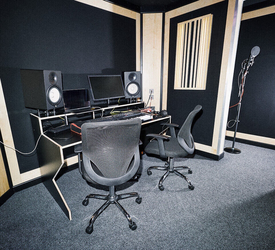 Recording studio - setup overview - piano, desk, chair, laptop, monitor, mixer and speakers 