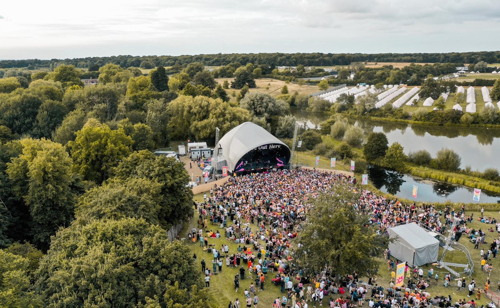 This image may contain: landscape, outdoors, nature, scenery, person, human, crowd, aerial view, festival, tent