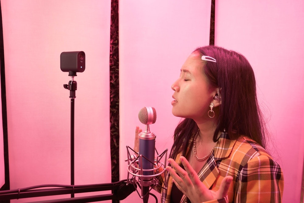 Woman using Logitech Microphone