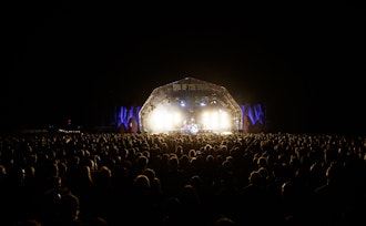 This image may contain: concert, crowd, person, stage, lighting, rock concert