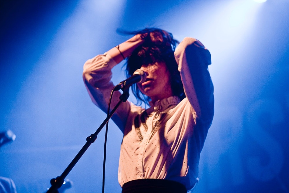 Woman singing into a microphone
