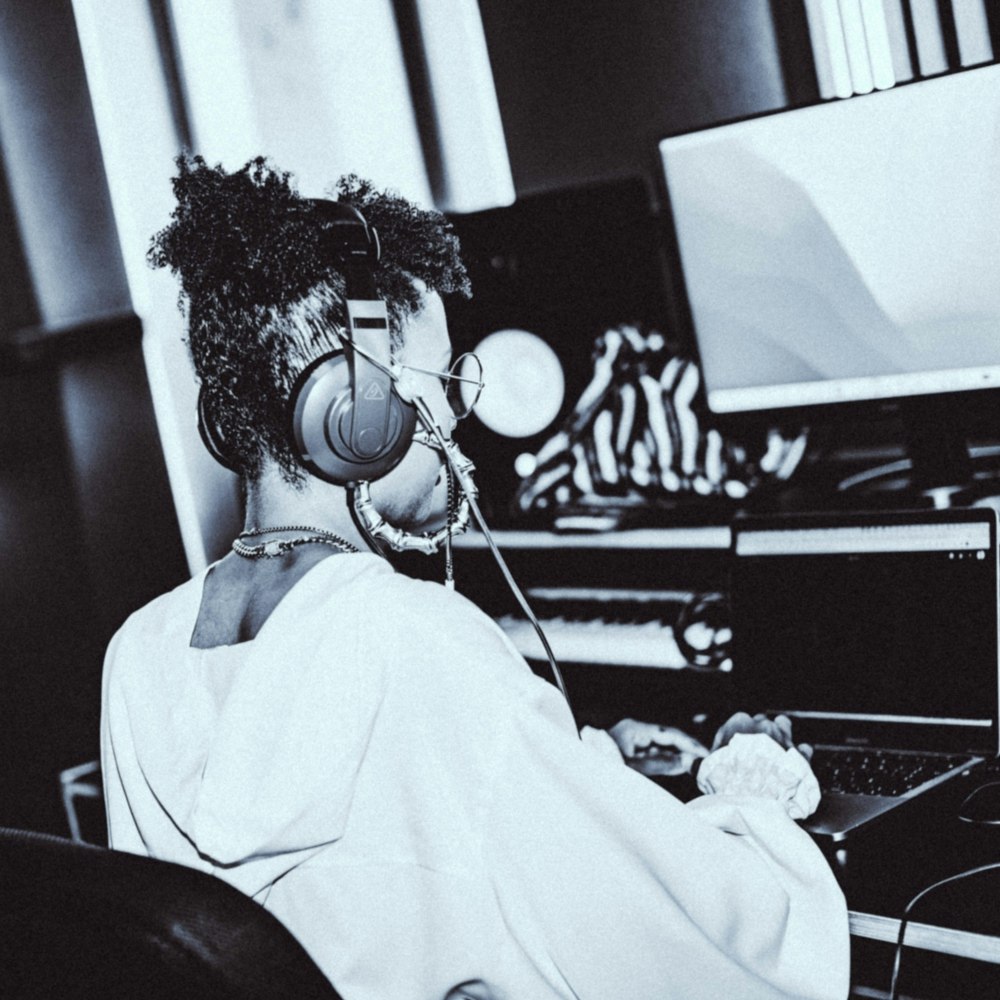 Black & white image of a woman producing music