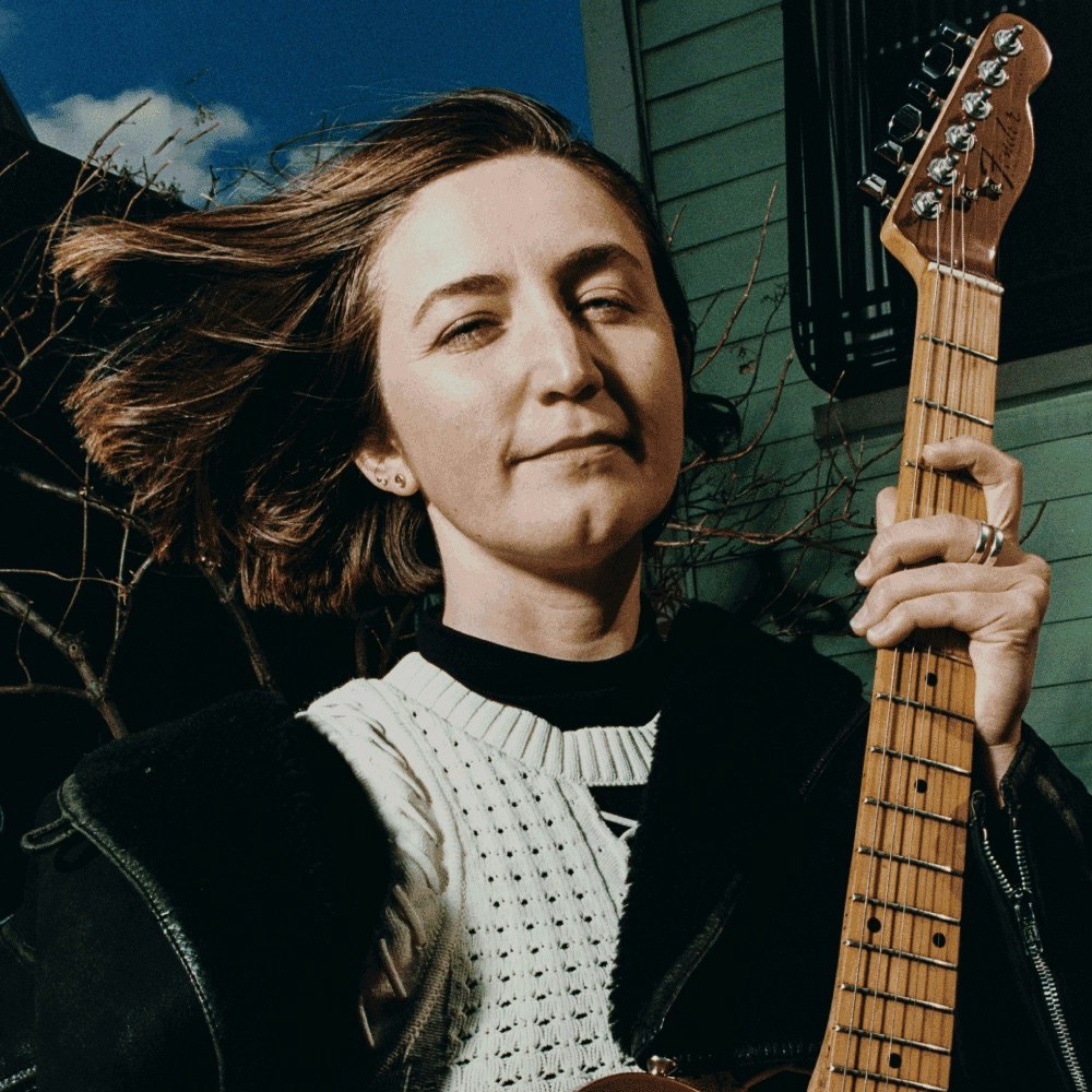 This image may contain: guitar, musical instrument, person, guitarist, musician, performer, face, happy, head, smile