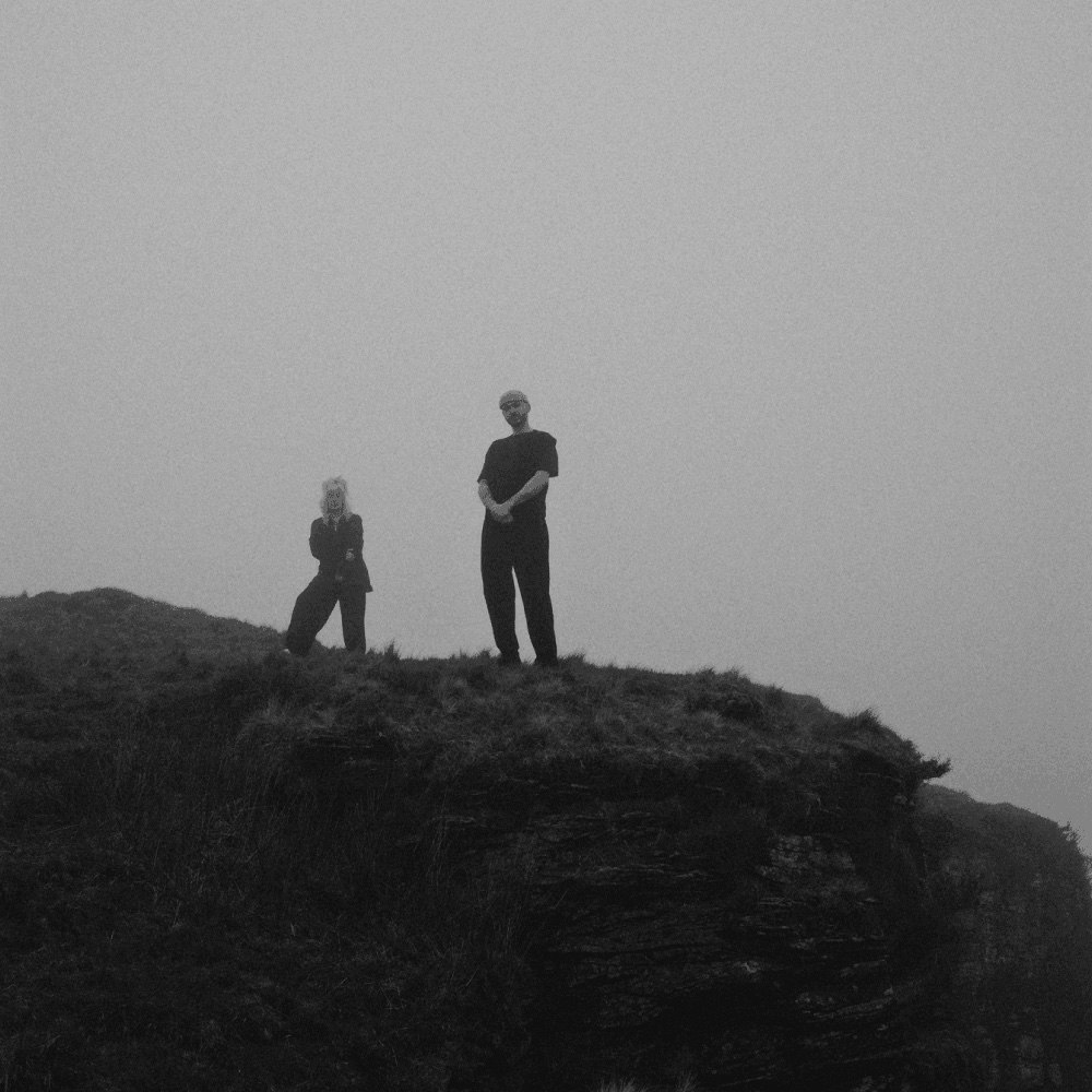 This image may contain: photography, rock, hiking, nature, outdoors, person, cliff, portrait, wilderness, walking