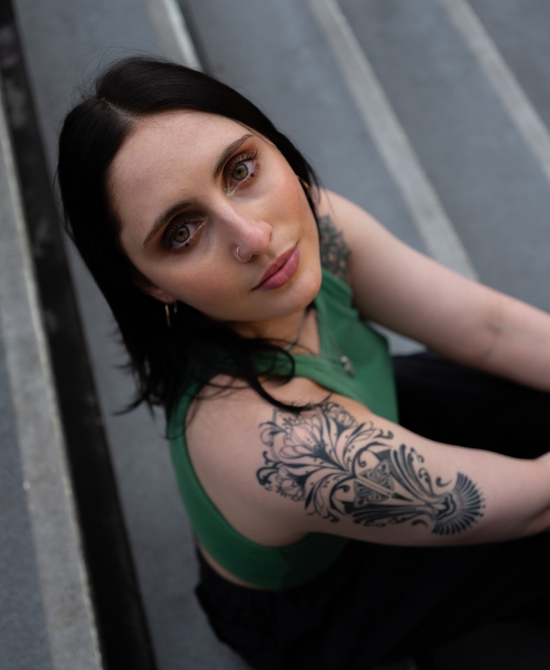 This image may contain: person, skin, tattoo, face, head