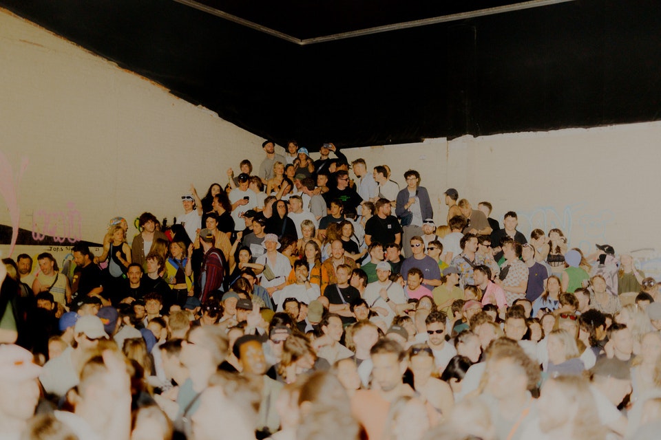 This image may contain: people, person, crowd, audience, concert, face, head, classroom, room, school