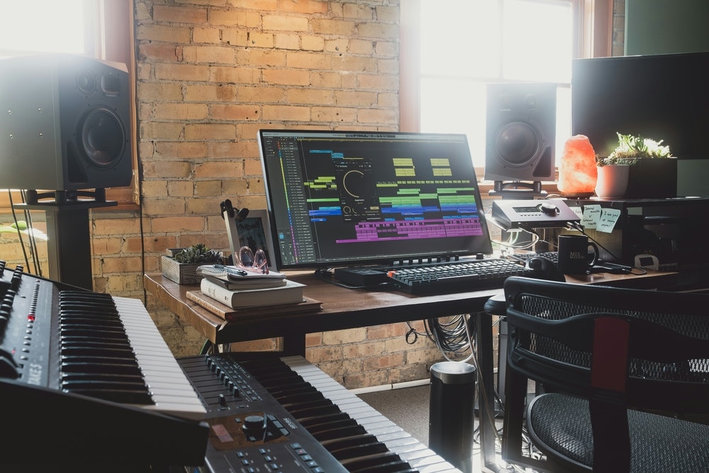 This image may contain: electronics, speaker, keyboard, piano, monitor, chair, music, musician, performer, playing keyboards