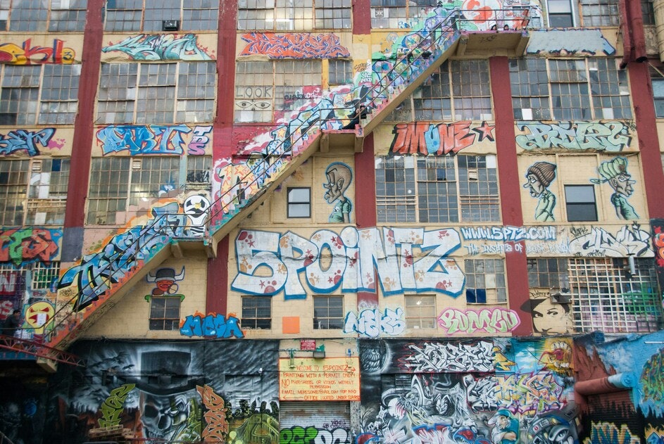This image may contain: architecture, building, city, art, graffiti, painting, urban, person