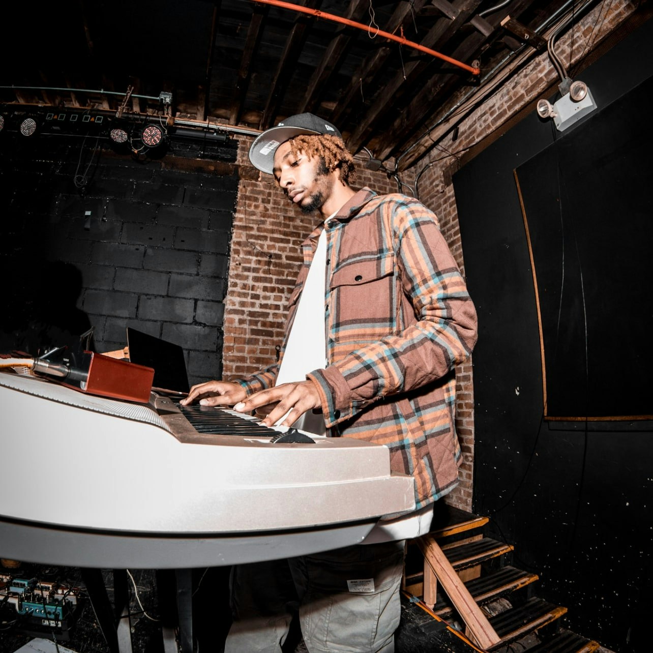 This image may contain: adult, male, man, person, musical instrument, piano, performer, music, musician, laptop