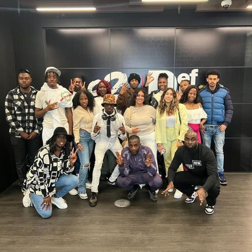 This image may contain: people, person, pants, groupshot, shoe, adult, male, man, jeans, hat