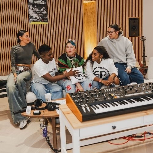 This image may contain: cup, adult, male, man, person, shoe, speaker, guitar, headphones, musician