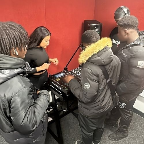 This image may contain: adult, female, person, woman, speaker, male, man, handbag, shoe, hat