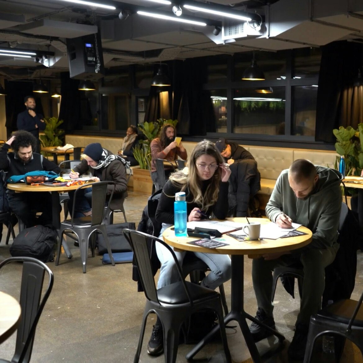 This image may contain: indoors, restaurant, cafeteria, cup, cafe, chair, shoe, adult, man, person