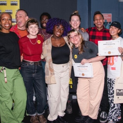 This image may contain: pants, people, person, hat, necklace, shoe, glasses, t-shirt, belt, portrait