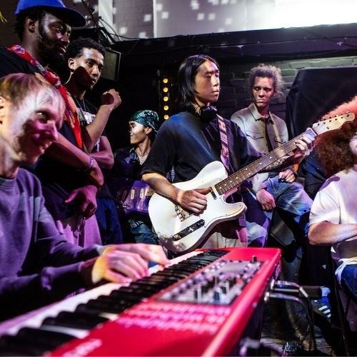 This image may contain: piano, hat, guitar, person, music, musician, performer, adult, male, man