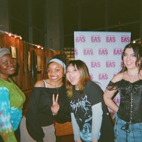 This image may contain: people, person, adult, female, woman, t-shirt, portrait, photobombing, pants, urban