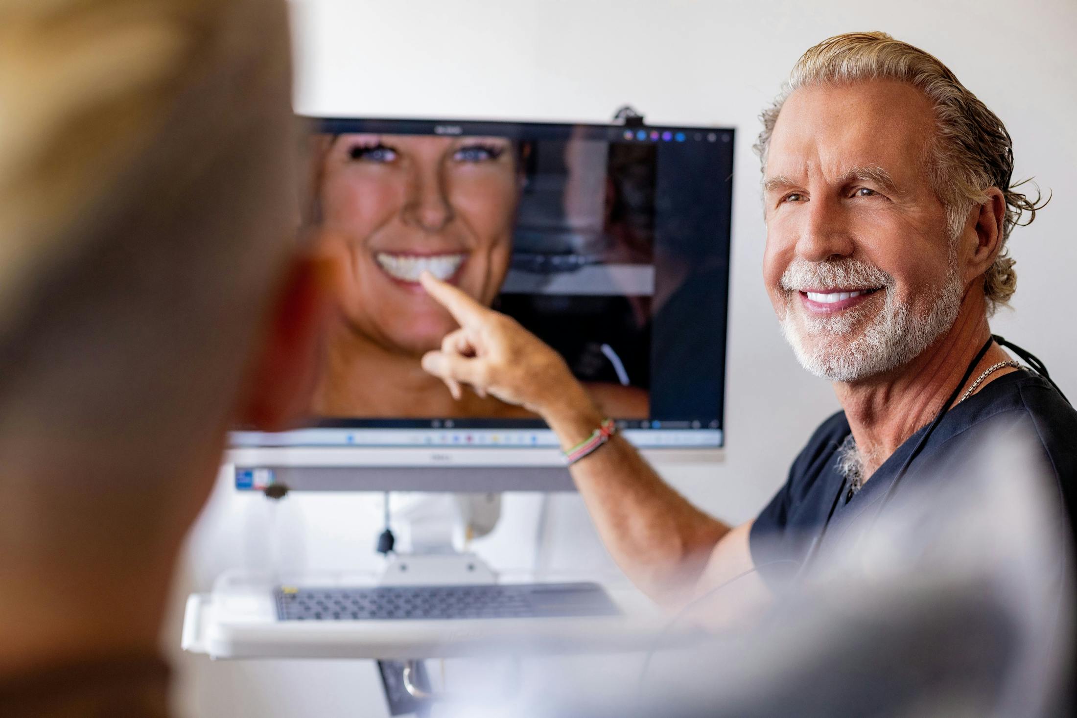 Dr. Paul O'Malley pointing to screen with patient's photo