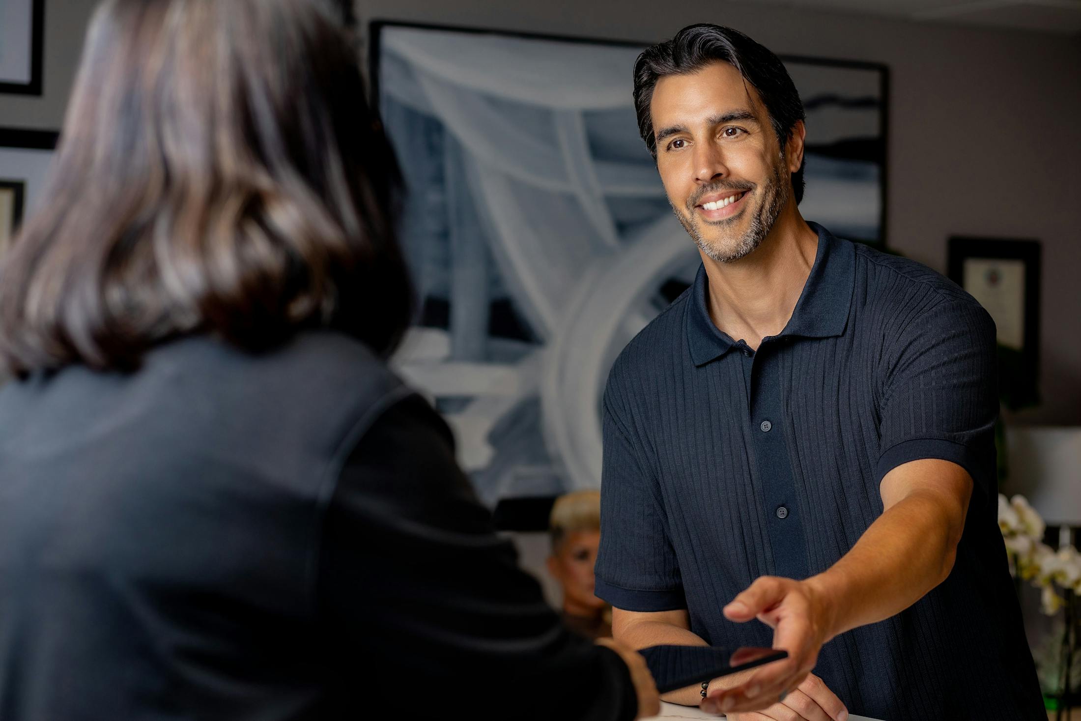 male patient getting folder from woman