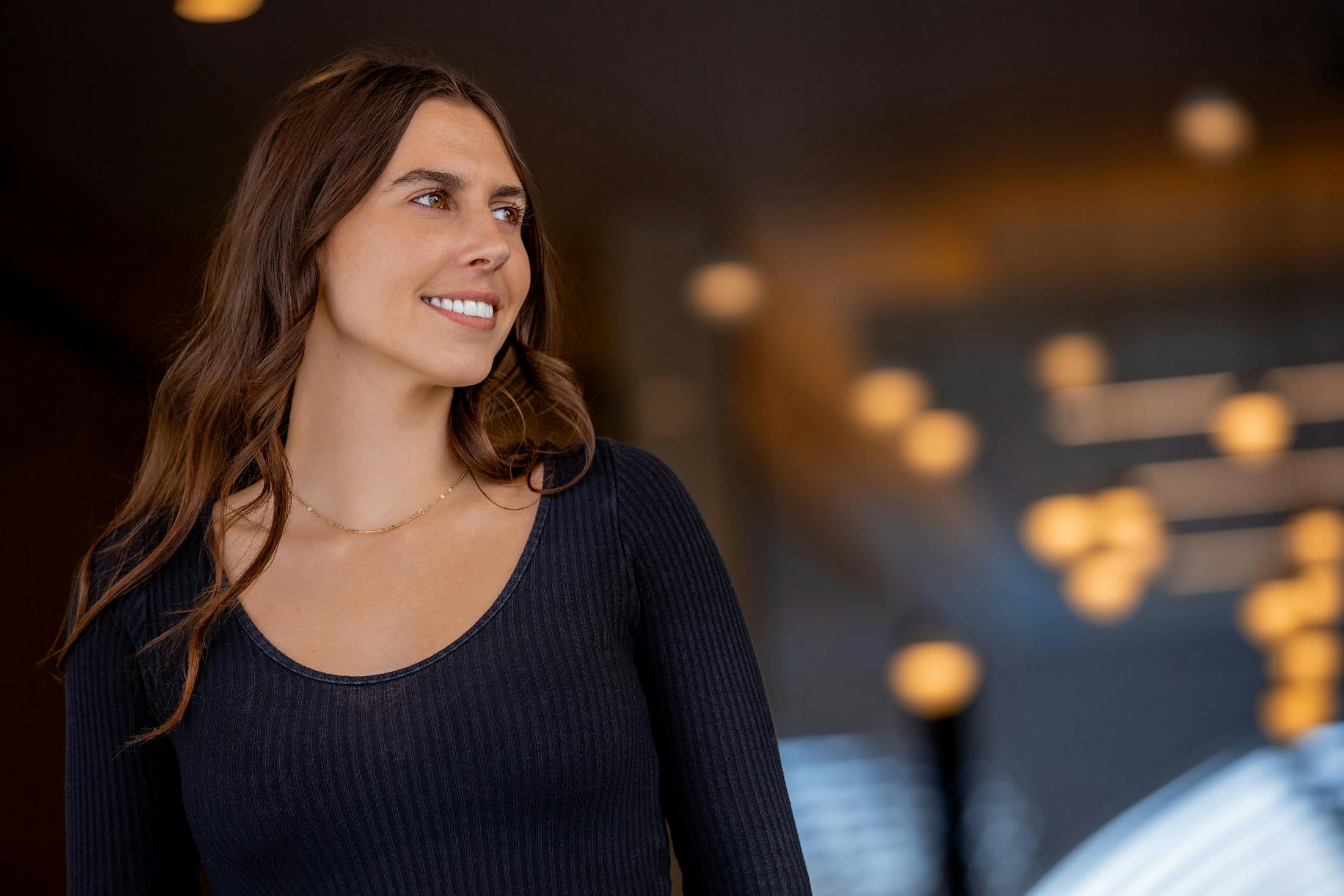 woman smiling while looking to the right