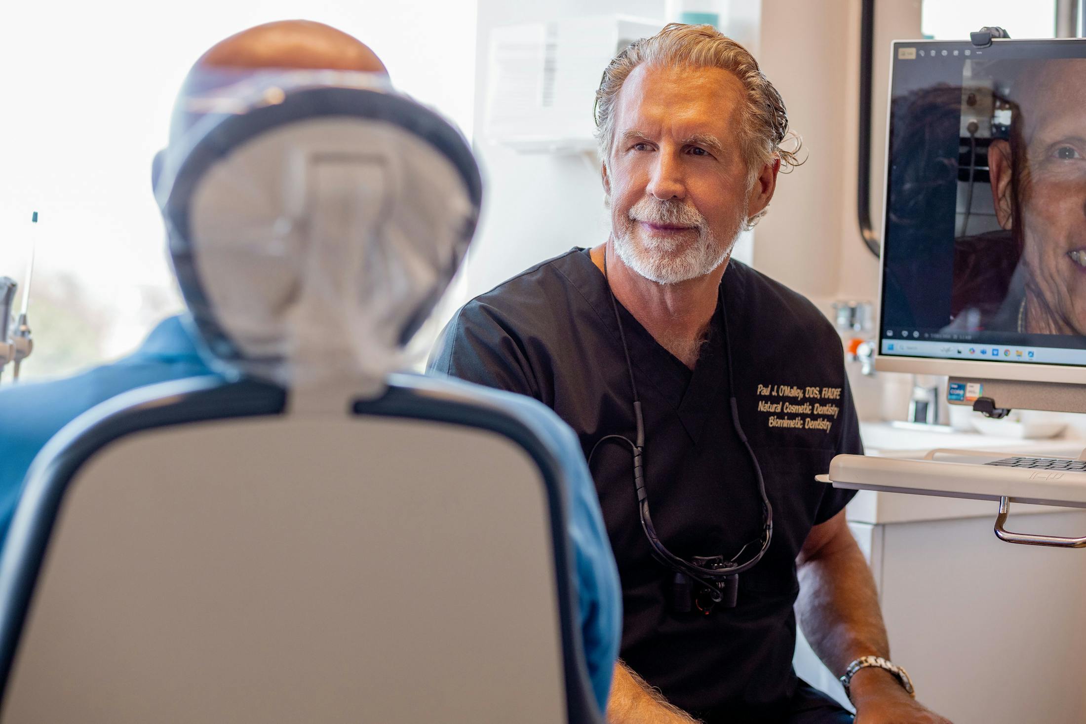 Dr. Paul O'Malley looking at patient