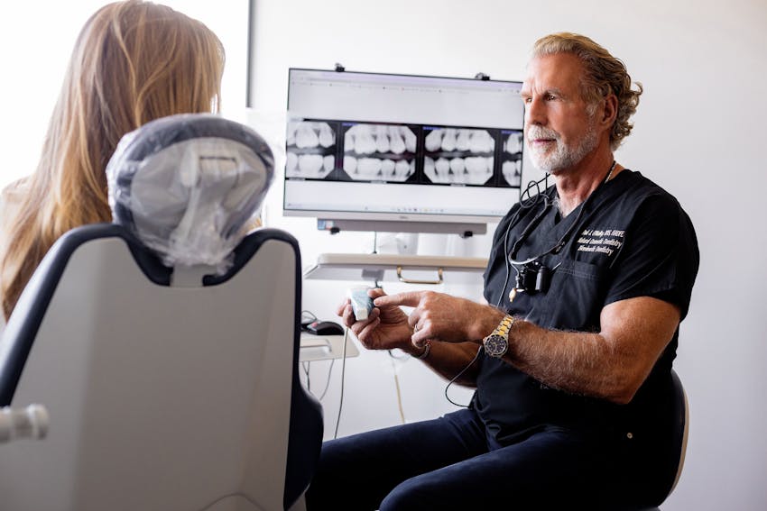 Dr. Paul O'Malley explaining x-rays to patient