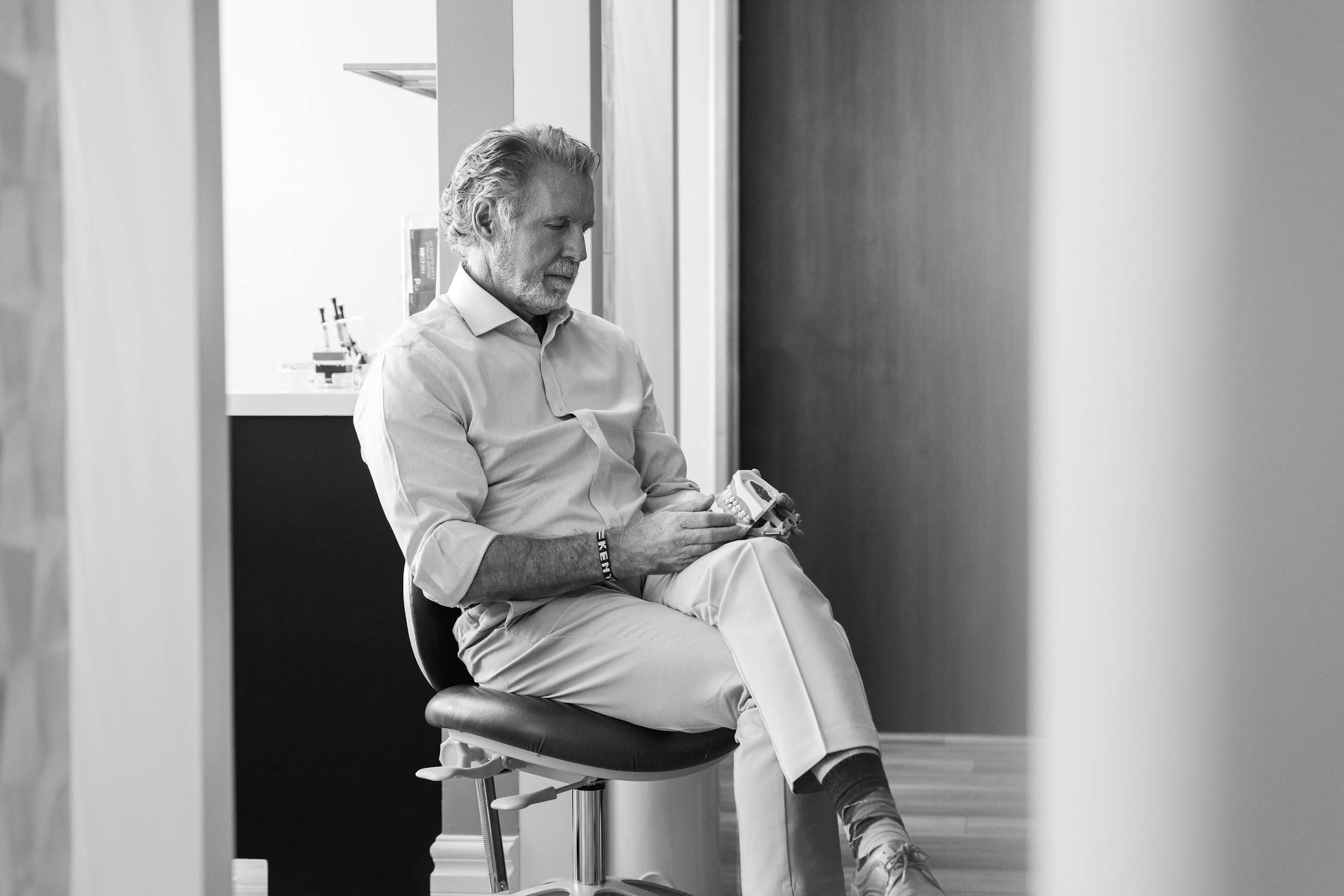 greyscale of Dr. Paul O'Malley sitting in chair