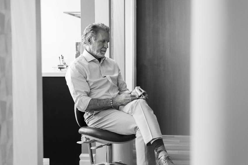 greyscale of Dr. Paul O'Malley sitting in chair