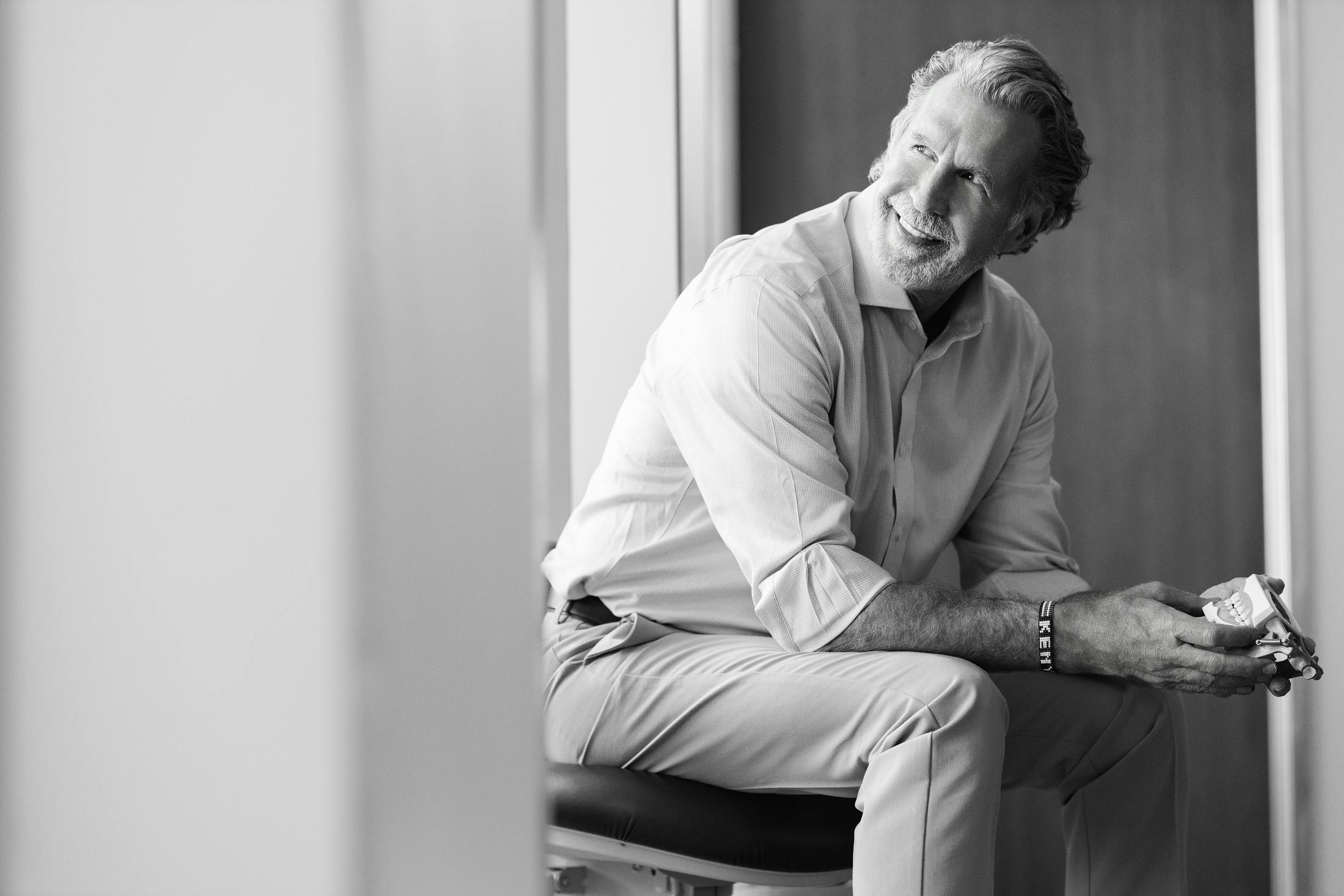 greyscale of Dr. Paul O'Malley sitting in chair