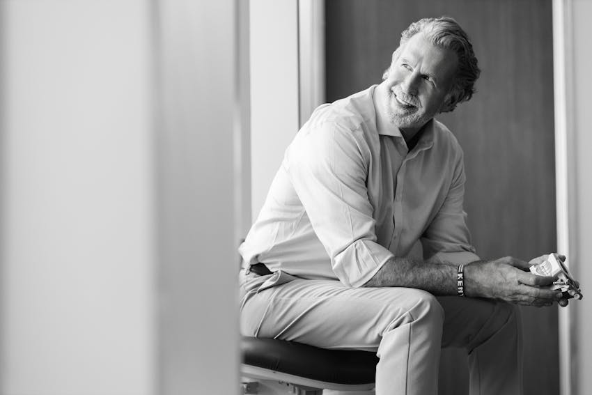 greyscale of Dr. Paul O'Malley sitting in chair