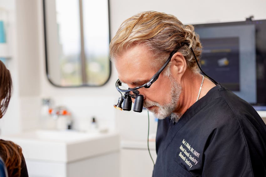 Dr. Paul O'Malley with glasses that are magnifying glasses