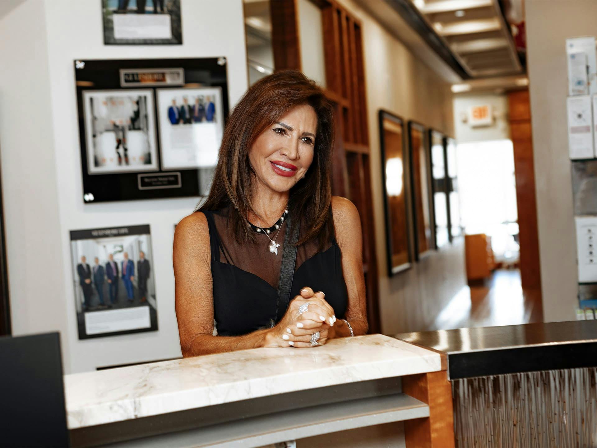 woman at counter with her hands together resting on it