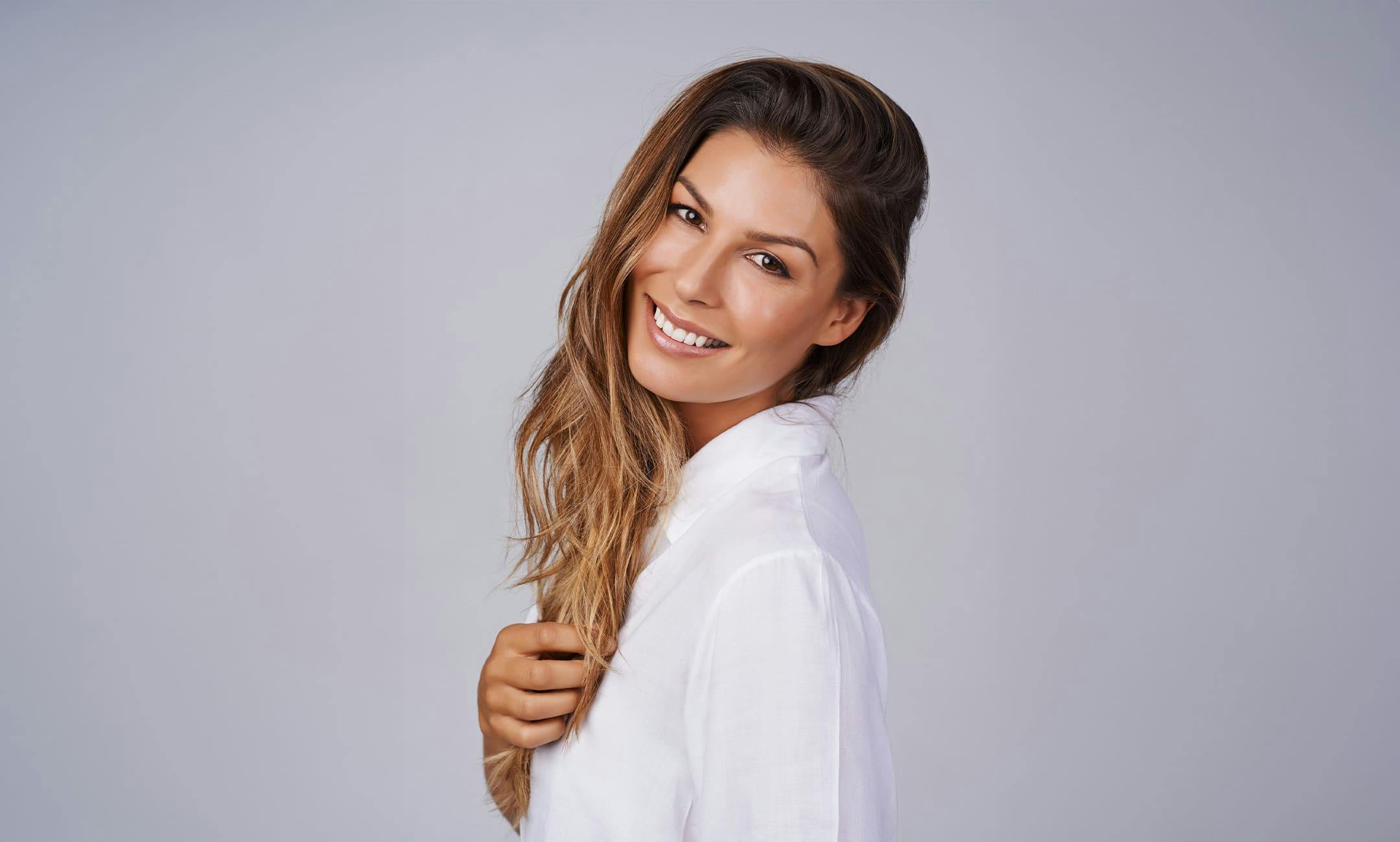 woman tilting her head back and smiling