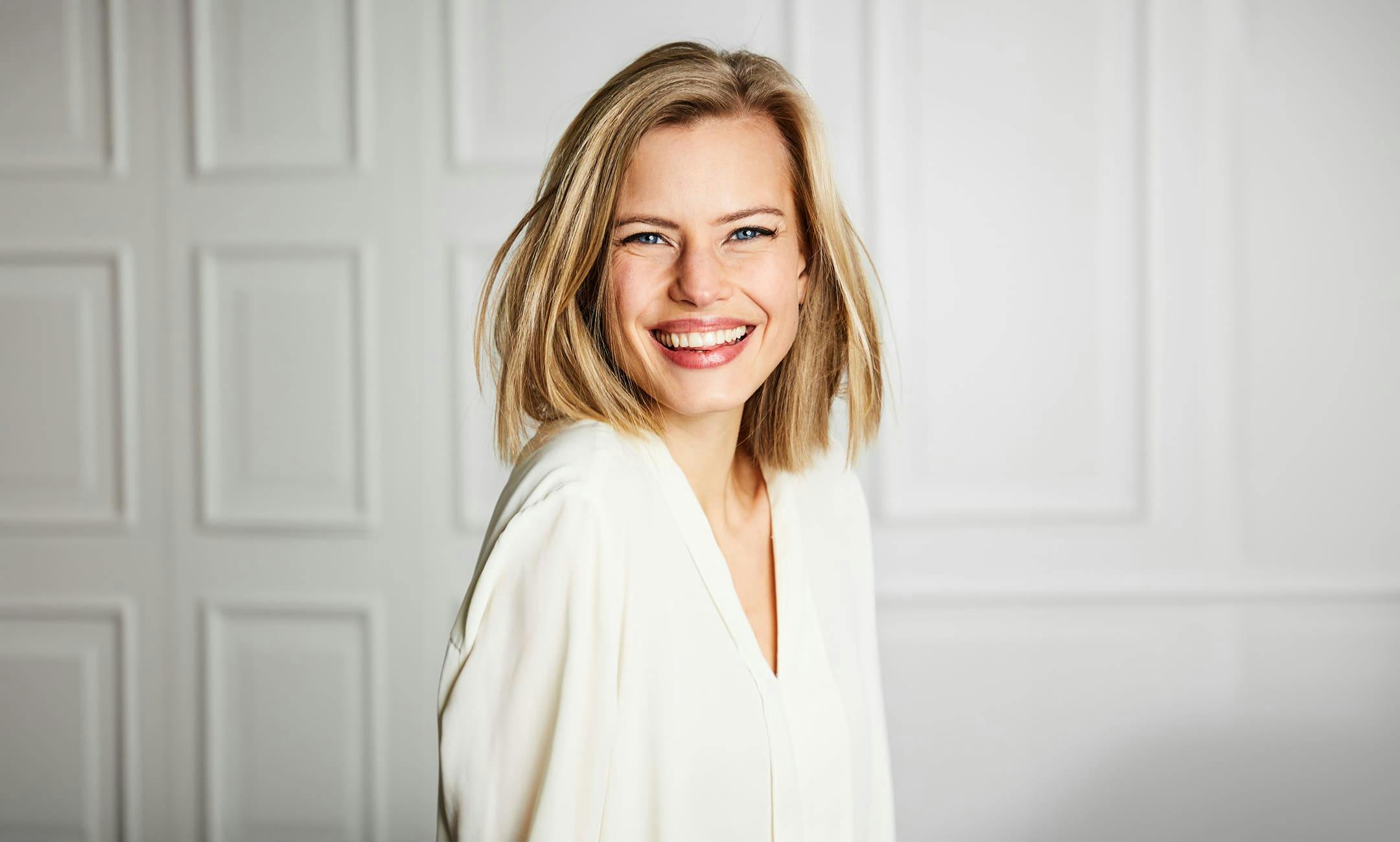 woman with short blonde hair smiling