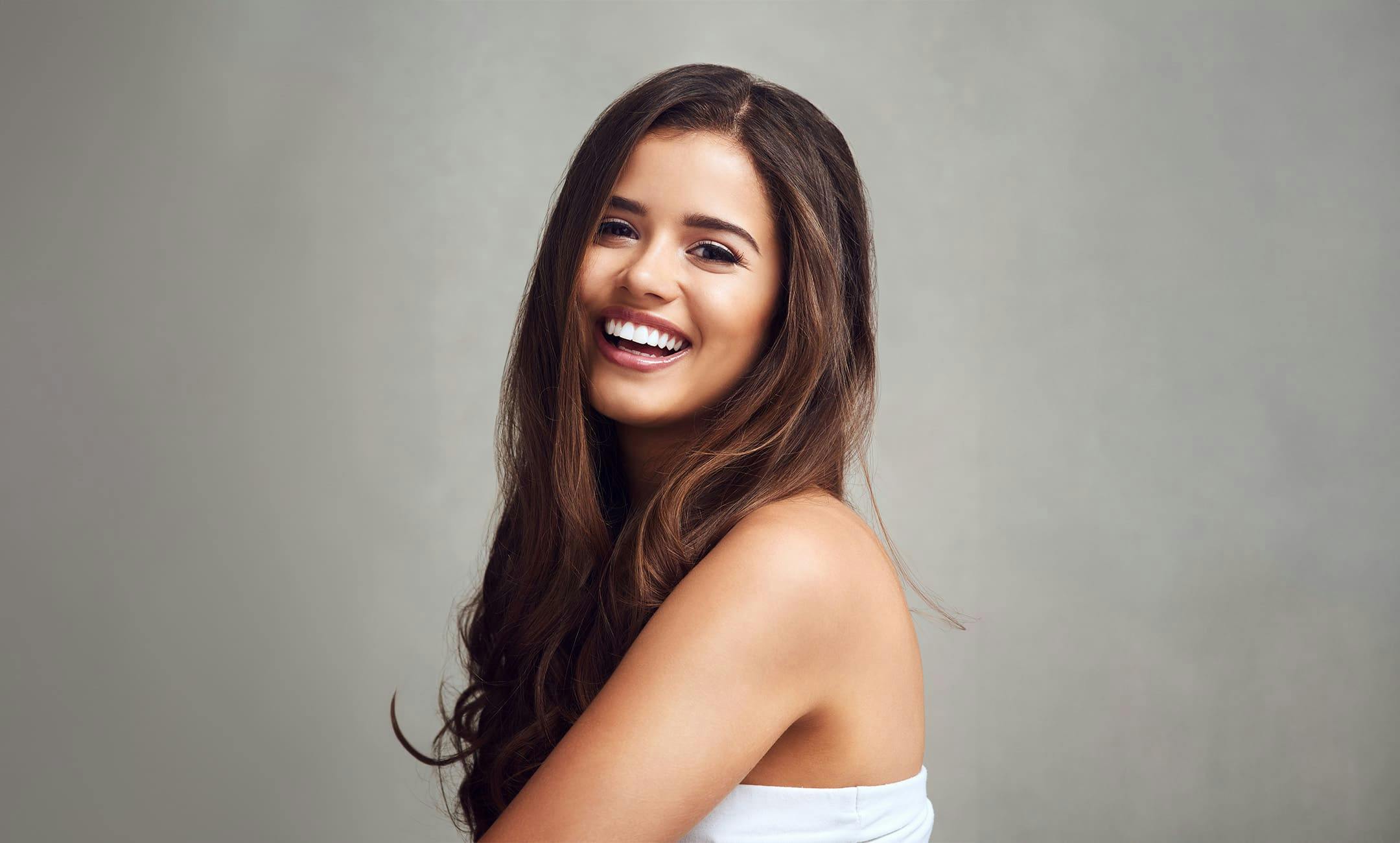 woman with long brown hair smiling