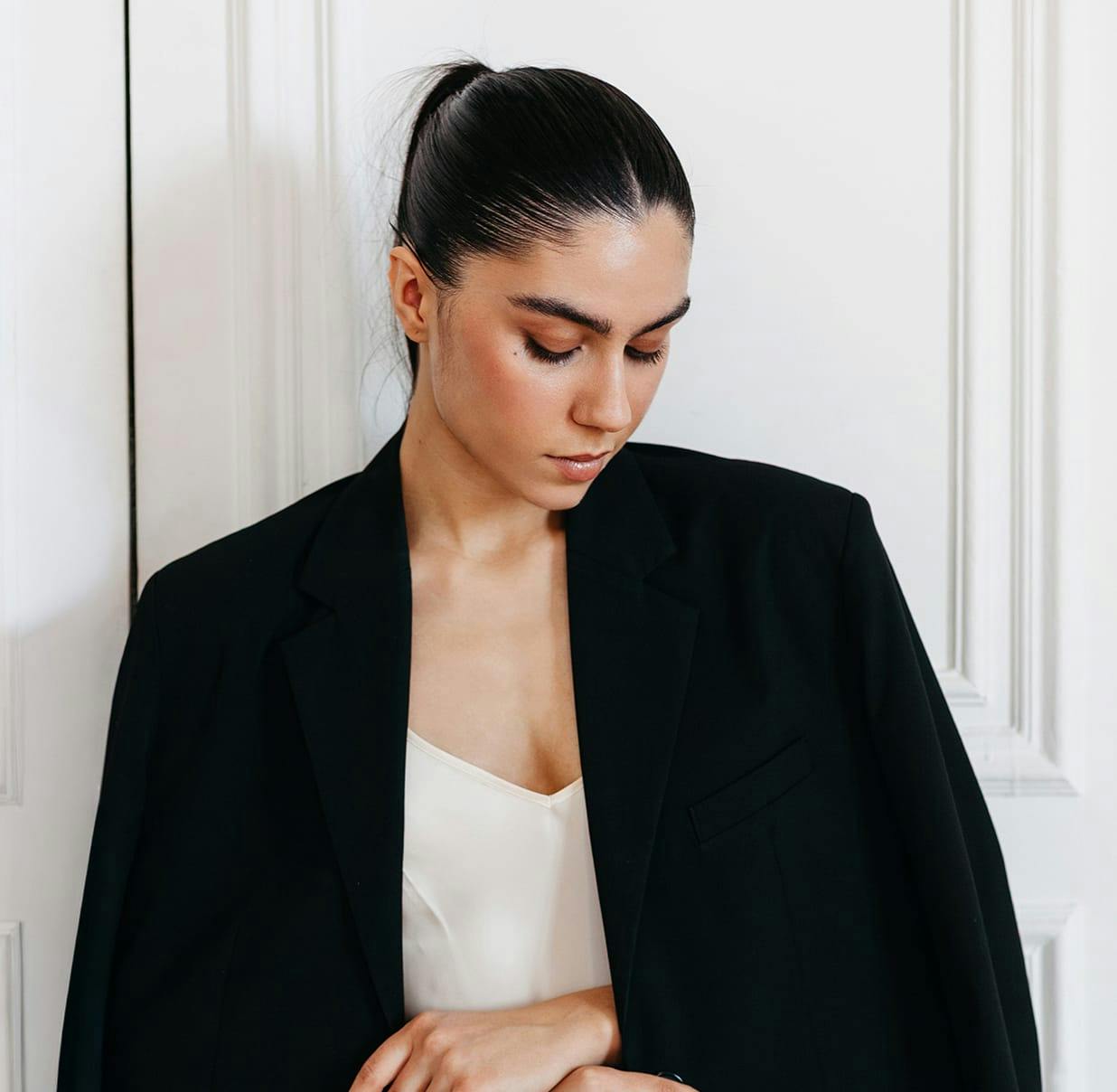 woman wearing a large black coat