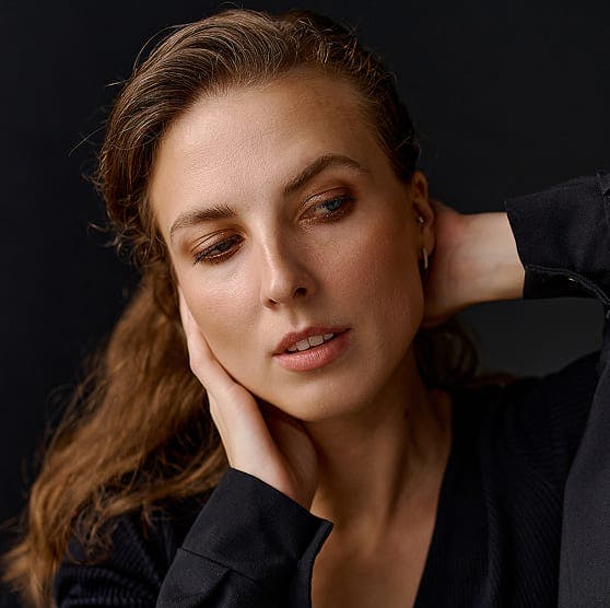 woman touching the side of her face