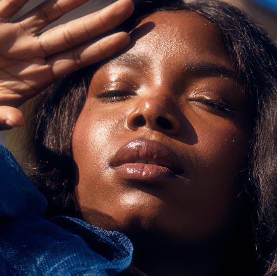 woman with her hand near her head