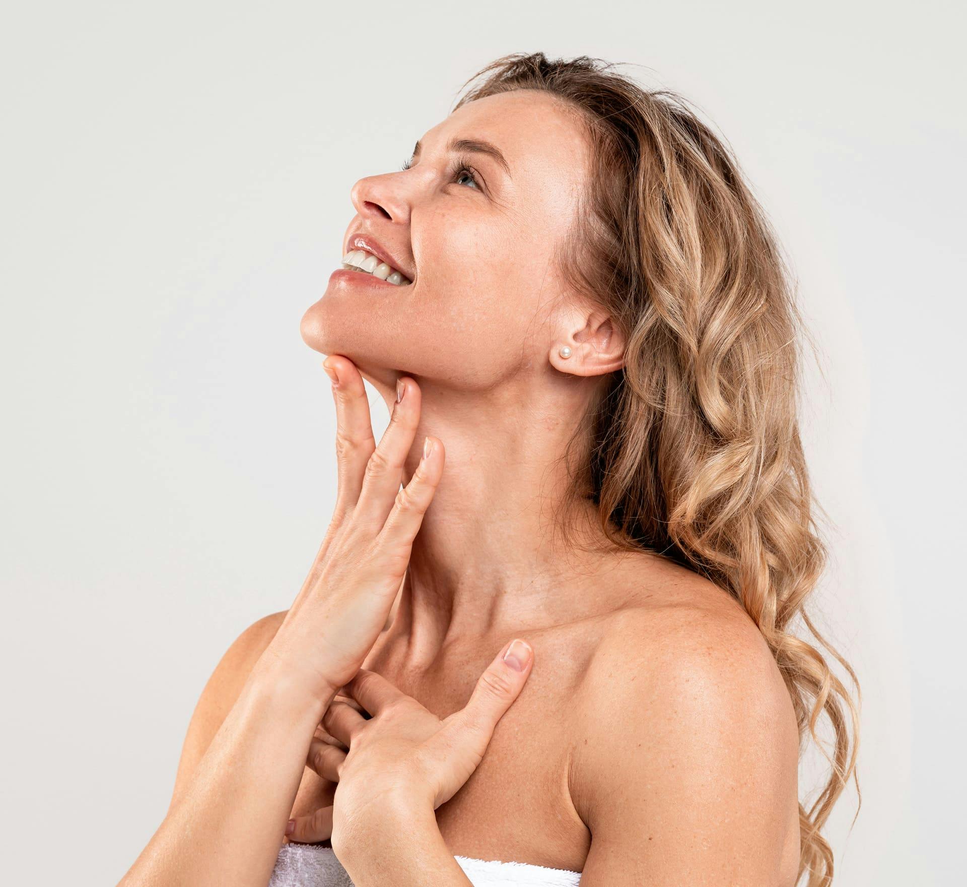 Woman smiling and touching chin
