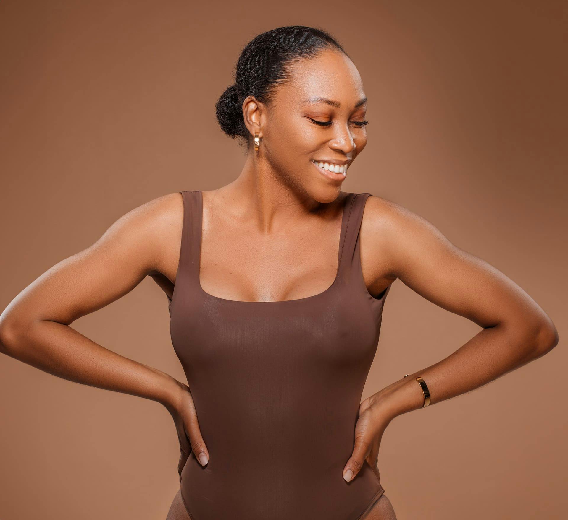 Woman smiling with hands on hips