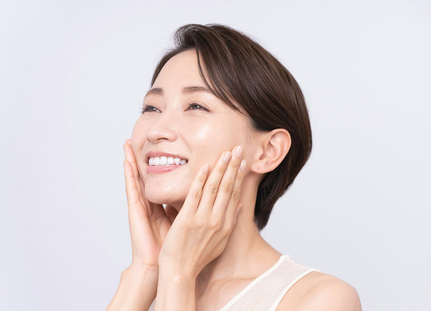 Woman smiling and touching face