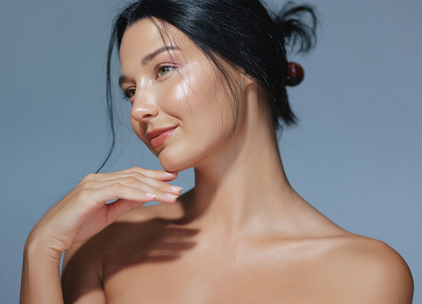 Woman smiling and touching chin