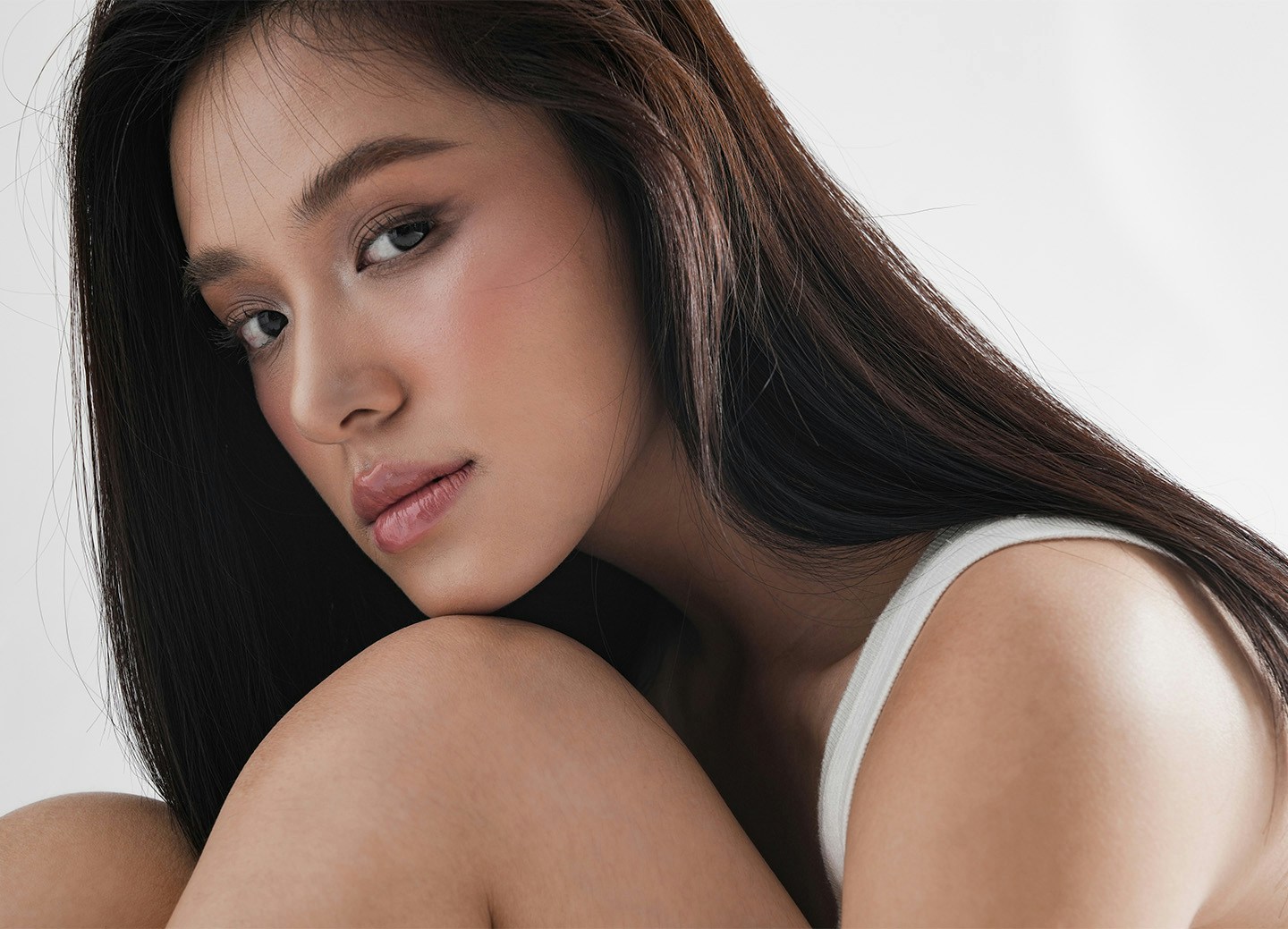 Woman resting chin on knee