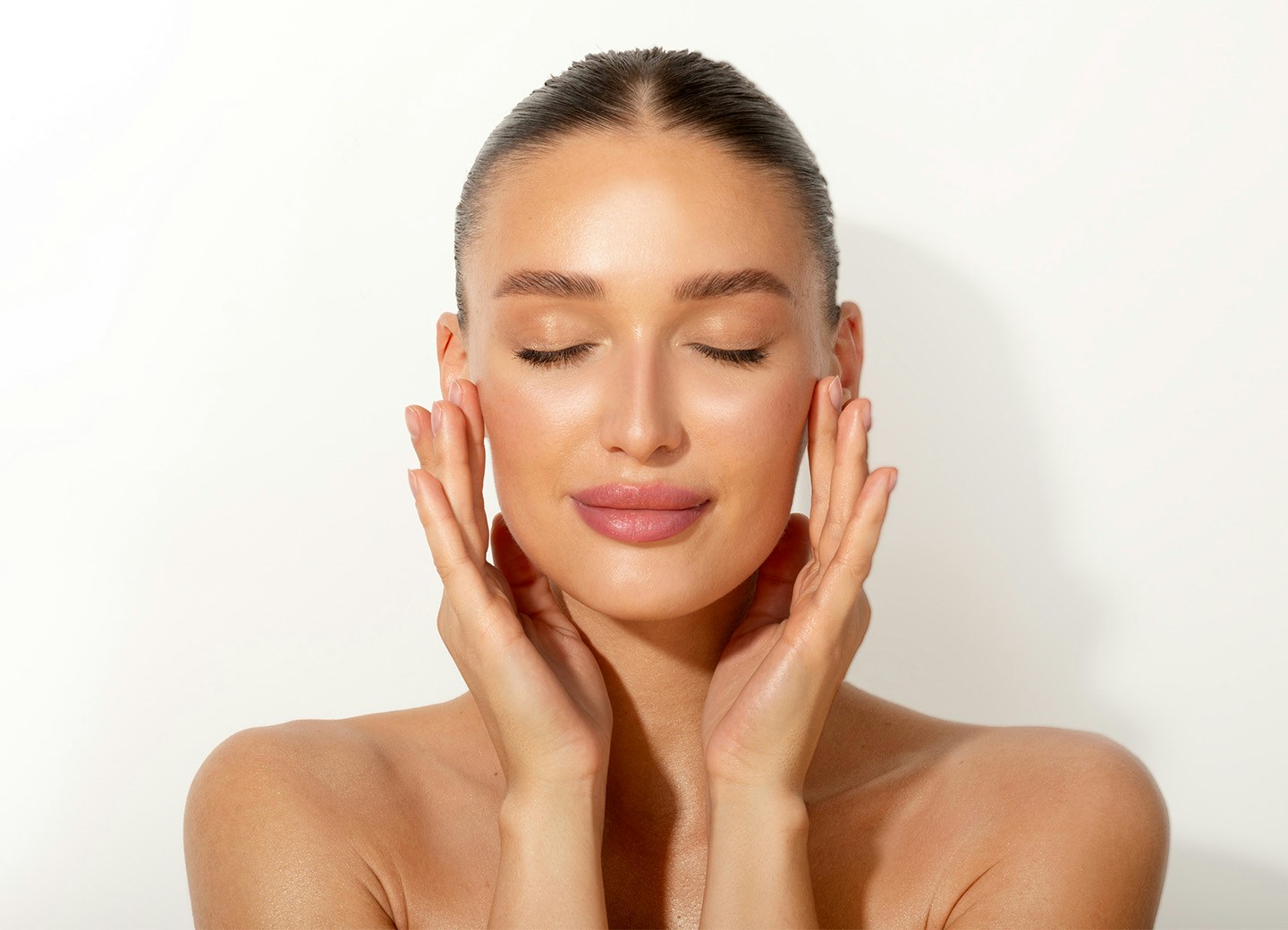 Woman closing eyes and touching face