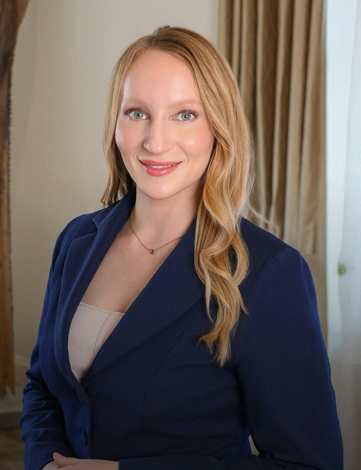 Portrait of Dr. Ellen M. Ezell in a lavender blazer, smiling
