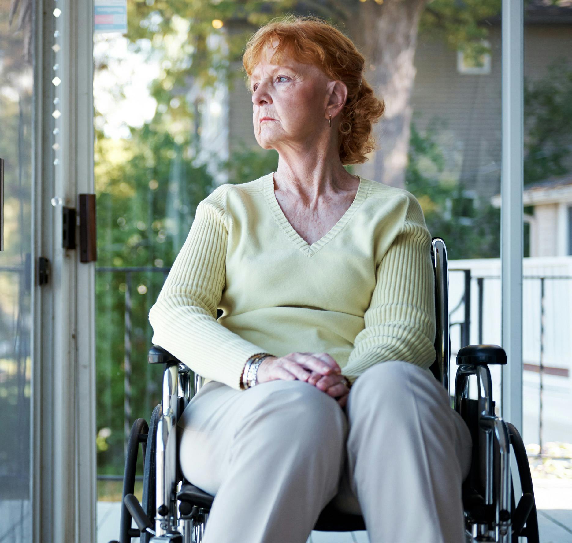ederly woman in wheelchair looking sad